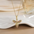Detailed close-up of a gold phoenix pendant with colorful zircon micro-inlay on a fine chain - FN0132 Colorful Pave Hollow Phoenix