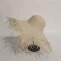 Detail of hand-woven straw sun hat with frayed edge design for beach vacation - M (56-58cm) / Beige