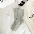 Minimalist heather grey ribbed crew socks in combed cotton on a soft linen background - One Size / Light Gray