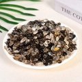 Polished natural black, clear, and smoky crystal stones displayed on white plate - Smoky Quartz (7-9mm) 100g