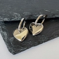 Orecchini a cuore in argento lucido presentati su una pietra di ardesia grigio scuro - Argento