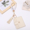 Detail of beige PU card holder and gradient silicone beaded keychain with a tassel - Beige