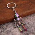 Handmade robot keychain made of nuts and bolts in a vibrant rainbow metallic finish - Iridescent