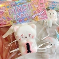 White cat squishy stress toy with pink fish bone accessory in branded blind bag - Pouty Cat