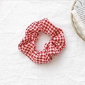 Classic red and white gingham fabric scrunchie with soft elastic pleated texture - Red