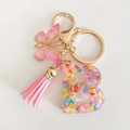 Pink resin alphabet B keychain with colorful heart sequins, butterfly, and tassel - Letter B