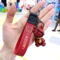 Detailed close-up of a geometric dark red French Bulldog keychain held in a person's hand - Single OPP Package / Burgundy