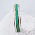 Detail of handmade woven bead bracelet in mint green and gold on white stone - Green