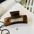 Macro detail of dark brown tortoiseshell hair claw clip with minimalist hollow rectangle design - Matte Light Tortoise