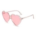 Pink heart-shaped sunglasses in translucent jelly finish shown at a 45-degree angle - Transparent Pink Frame Pink Lens
