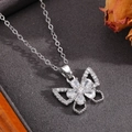 Detail of silver bow pendant necklace with sparkling crystals on grey textured fabric - Silver Bowknot Flower Diamond Necklace