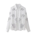 Close-up of intricate floral embroidery and button detail on white cotton shirt - XS / Tops / White