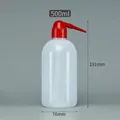 Detailed macro view of 500ml translucent plastic wash bottle with red curved precision nozzle - 500ml (Red Tip)