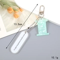 Detail of mint green marble acrylic number keychain with a white charm and silver lobster clasp - Letter I