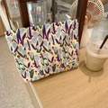 Detail of canvas tulip makeup bag showing floral print and Sozakka brand label - Tulip Blue Branch