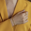 Wheat chain gold bracelet and minimalist round ring set shown on model in yellow suit - Gold Texture Bracelet
