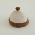 Detail of baby knitted beanie with pompom showing fine ribbed texture and soft fabric - 50-52cm (2-4 Years) / Rice White & Brown