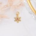 Detailed macro view of 18k gold plated snowflake pendant with red zircon center and crystals - Gold with Red Zircon