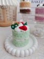 Detailed close-up of a green double-layer strawberry cake scented candle with waffles - Mint Cake (Romantic House)