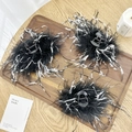 Three-piece set of elegant black ostrich feather shark clips with white spots on wood tray - Black & White Feather Claw Clip Small 9.5cm