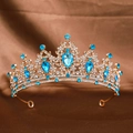 Detailed close-up of a golden bridal crown featuring blue gemstones and sparkling rhinestones - Gold Lake Blue