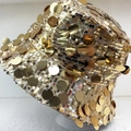 Sparkly gold sequin bucket hat for women with a foldable design on a clear stand - M / Gold