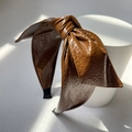 Retro dark brown PU leather headband with a large bow on a minimalist white stand - Brown