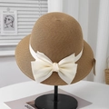 Detailed close-up of brown straw sun hat featuring a large ivory silk bow and fine weave - Adjustable (57.5cm) / Camel