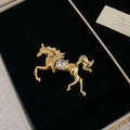 Macro detail of a running horse brooch with gold-plated alloy and sparkling rhinestones - Gold Running Horse with White Rhinestones