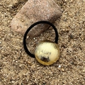 Golden brushed metal circle hair tie with black high elastic rope on desert rock - Brushed Round Gold