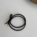 Detail of black elastic hair tie with minimalist bow knot and golden metal tips - Black