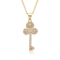 Detailed macro view of 18k gold heart key pendant necklace with sparkling zircon pavé - Triple Ring Snowflake Petal Key Style (c180)