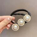 Elegant black elastic hair tie with three white faux pearl flower charms and gold base - Pearl Style