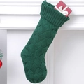Dark green cable knit Christmas stocking hanging on a white fireplace mantel - Green