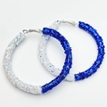 Detailed view of large C-shaped hoop earrings with blue and white shimmering sequins - Blue & White