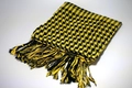 Close-up of black and yellow houndstooth desert scarf with decorative fringe details - Yellow