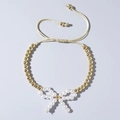 Adjustable evil eye bracelet with gold beads, white pearls, and a bowknot charm - Gold Pearl Bow (JS-B24022901A)