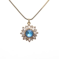 Golden sunflower necklace with central blue sapphire and sparkling zircon crystals - Light Blue