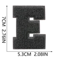 Close-up detail showing dimensions 7cm by 5.3cm of the black chenille letter E patch - Letter E / Black