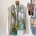 Long green water lily print silk scarf accessory styled on a beige blazer jacket - Oil Painting Creek