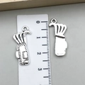 Antique silver golf bag charms for DIY jewelry making shown with measurement ruler - Golf Bag