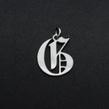 Detailed macro view of silver Gothic letter G pendant with stainless steel finish - Letter G