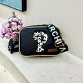 Chic black crossbody bag with white ARCHUA lettering strap and gold metal hardware - Black