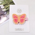 Detailed view of handmade glittery butterfly hair clip on white packaging card - Rose Yellow Butterfly
