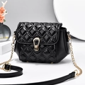 Classic black quilted leather crossbody bag with gold chain strap on minimalist background - Black
