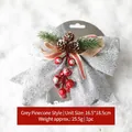 Silver sequin Christmas bow with pine cones and red berries on a white snow background - Silver Pine Cone Christmas Bow