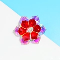 Elegant floral brooch with red and iridescent crystals on a polished silver metal base - White Red