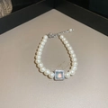 Detail of pearl bracelet featuring a square iridescent gemstone charm and silver chain - Artificial Pearl Bracelet Style 86