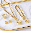 Golden heart jewelry set with pearl necklace, stud earrings and matching ring on marble - Heart Style