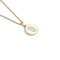 Macro detail of golden prayer silhouette on a white enamel circular pendant necklace - Gold Round Praying Style
